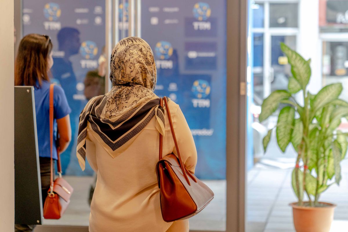 Visitors entering a conference venue