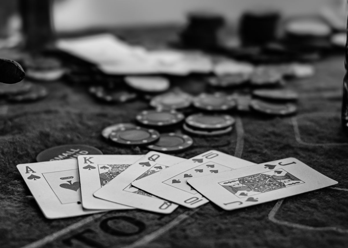 black and white photo of poker cards and chips