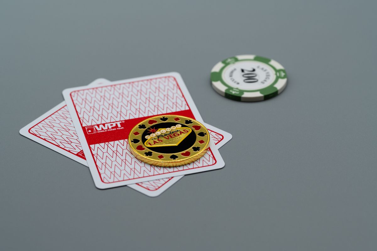 las vegas poker chips and cards on grey surface