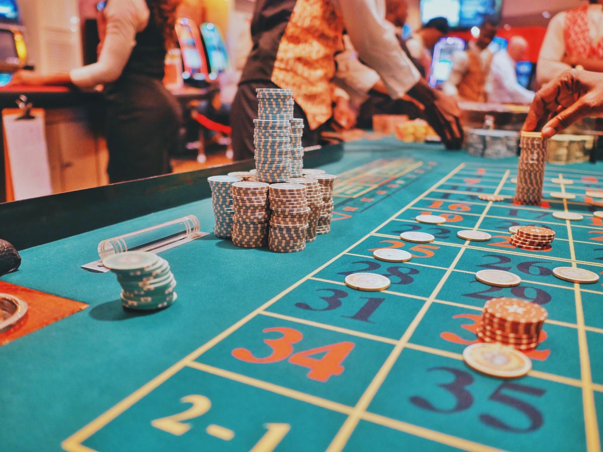 people near roulette table in casino