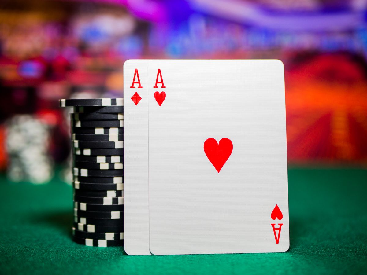 playing cards beside and casino chips on green table